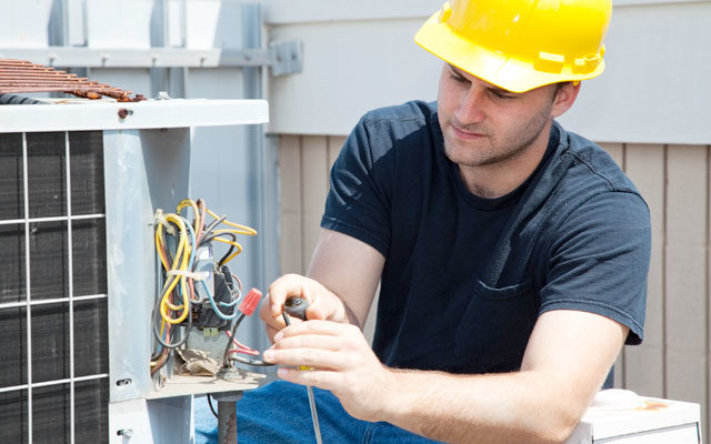Heating and Cooling Technician making repairs